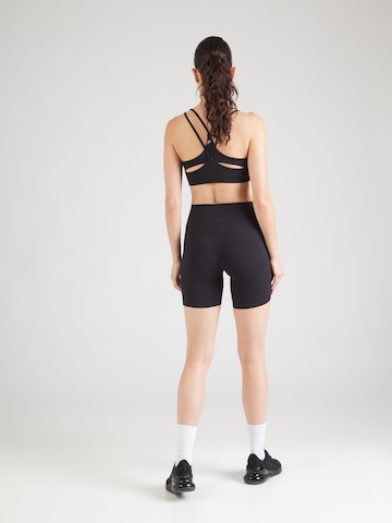 Skinny Pantalon de sport 'Motion' UNDER ARMOUR en noir