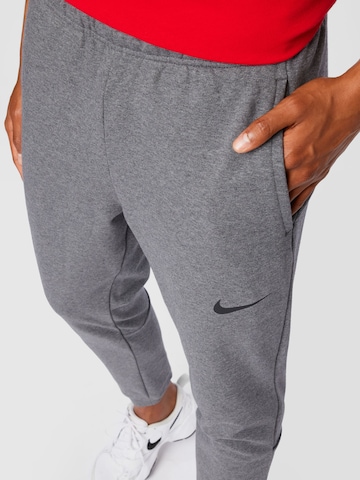 NIKE Tapered Workout Pants in Grey