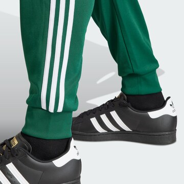 ADIDAS ORIGINALS Tapered Pants 'Adicolor Classics Sst' in Green