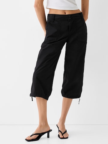 Bershka Regular Trousers in Black: front