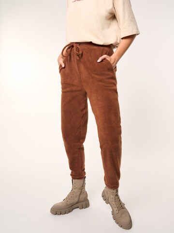 ABOUT YOU x Laura Giurcanu Tapered Pants 'Holly' in Brown: front