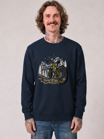 Sweat-shirt 'Mountainbike und Berge' Watapparel en bleu : devant