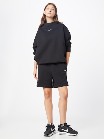 Nike Sportswear Ohlapna forma Hlače 'Phoenix fleece' | črna barva