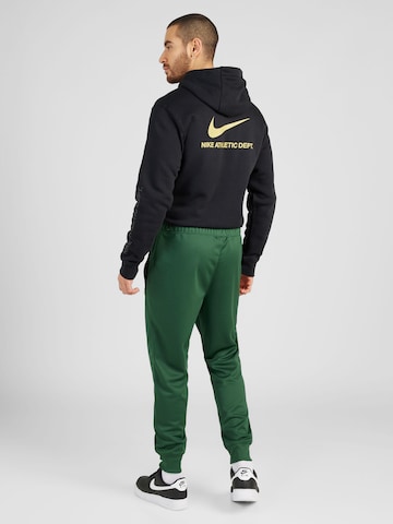 Tapered Pantaloni di Nike Sportswear in verde