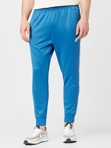 Tapered Pantaloni de la Nike Sportswear pe albastru: față