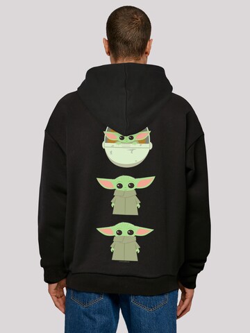 Sweat-shirt 'Star Wars The Mandalorian The Child Poses' F4NT4STIC en noir : devant