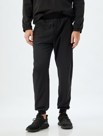 Koton Tapered Trousers in Black: front