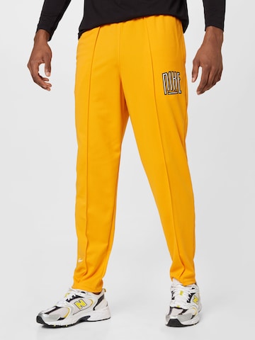 NIKE Tapered Workout Pants in Yellow: front