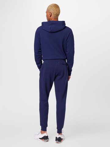 Effilé Pantalon de sport UNDER ARMOUR en bleu