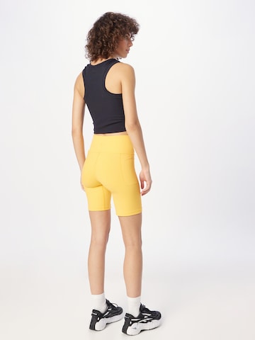 UNDER ARMOUR Úzky strih Športové nohavice 'Meridian' - Žltá