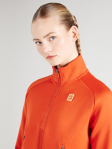 Bluză cu fermoar sport de la NIKE pe portocaliu