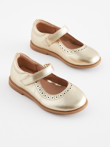 Next - Bailarina en oro