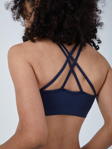 SPORTKIND Medium support Sport bh 'Crossed Straps' in Blauw