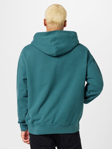 LEVI'S ® Collegepaita 'Gold Tab Hoodie' värissä vihreä