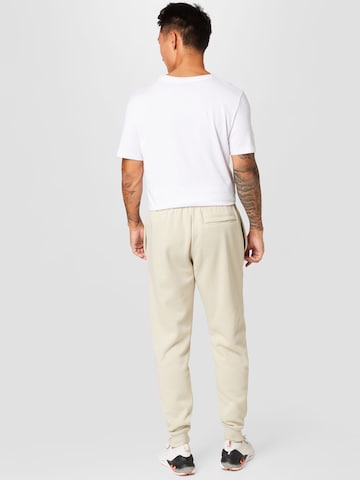 UNDER ARMOUR Tapered Sportsbukser 'Rival' i grøn