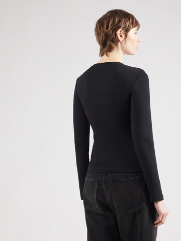 Maglietta di GUESS JEANS in nero