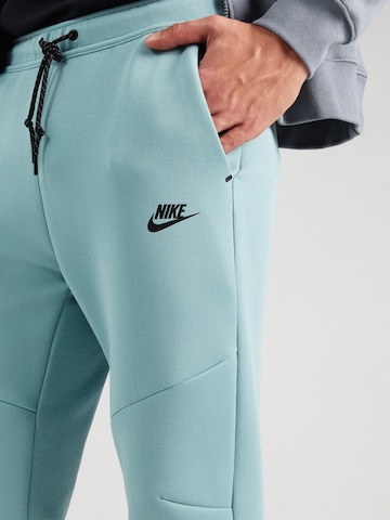 Effilé Pantalon 'TCH FLC' Nike Sportswear en vert