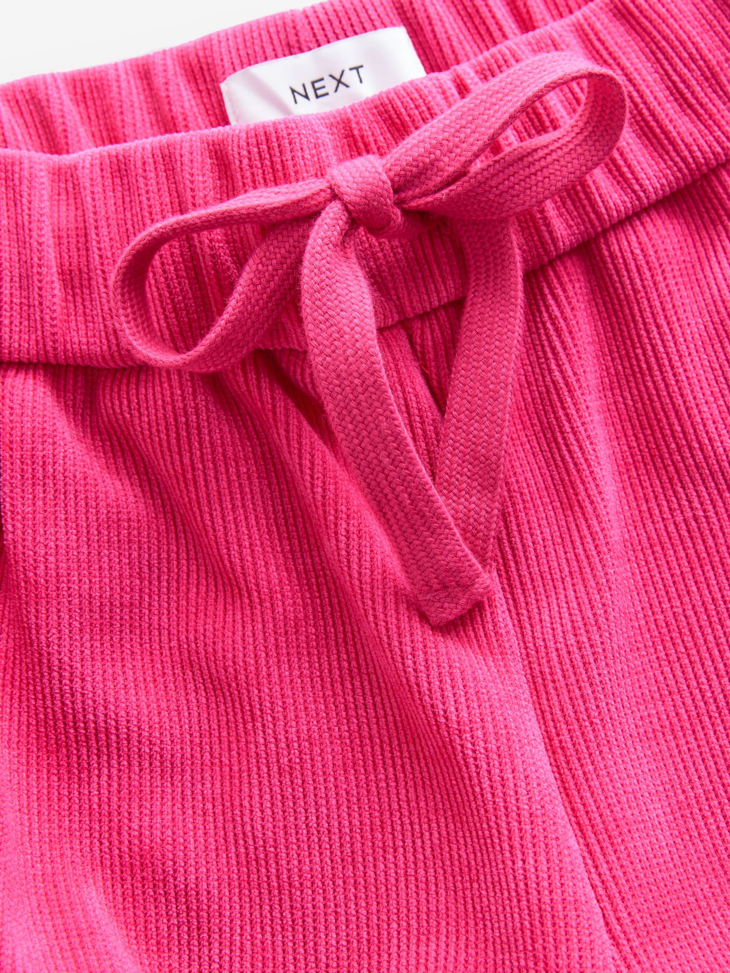 Next - Perna larga Calças em rosa