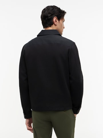 TOMMY HILFIGER Välikausitakki 'ESS' värissä musta