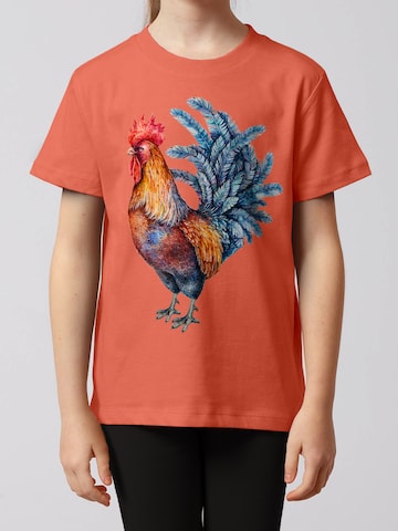 watabout.kids Shirt 'Grimmiger Gockel' in Orange: front