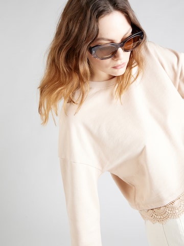 Sweat-shirt 'Georgeia' ABOUT YOU en beige