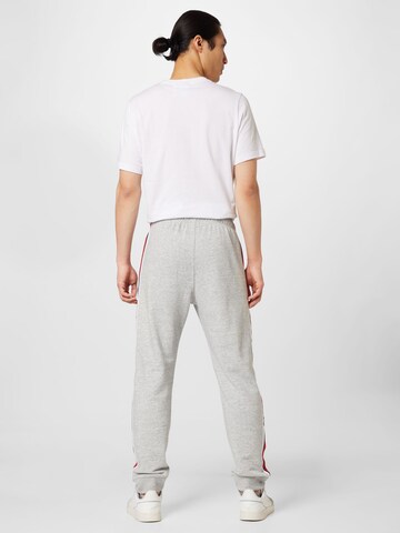 Champion Authentic Athletic Apparel Tapered Housut värissä harmaa