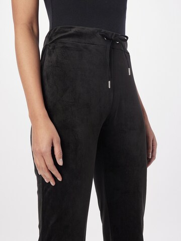 Gina Tricot Flared Pants 'Melinda velour trousers' in Black