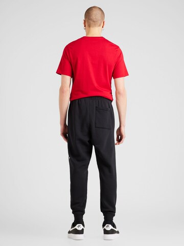 Tapered Pantaloni 'ESS' di Jordan in nero