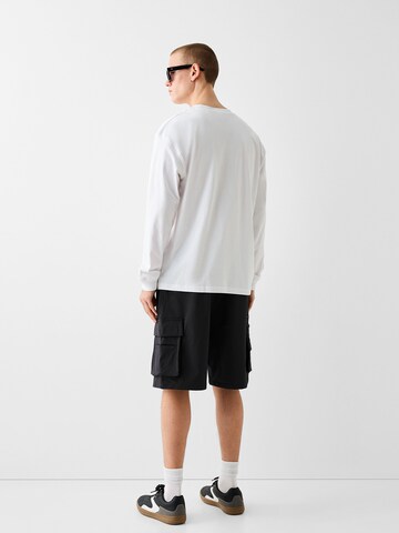 Bershka Regular Cargo trousers in Black