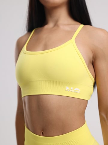 neverover - Bustier Sujetador deportivo 'Hue Cross-Back Strappy Bra' en amarillo
