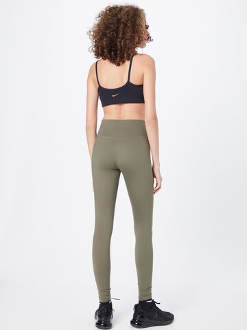 NIKE Skinny Športne hlače 'One Luxe' | zelena barva