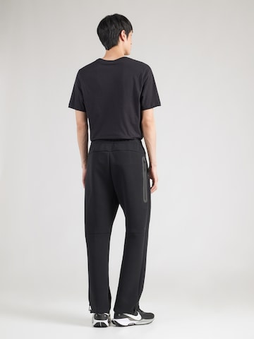 Nike Sportswear Loosefit Housut 'TECH FLC' värissä musta