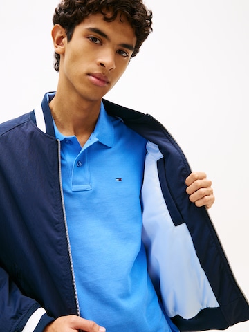 Tommy Jeans Átmeneti dzseki 'VARSITY' - kék