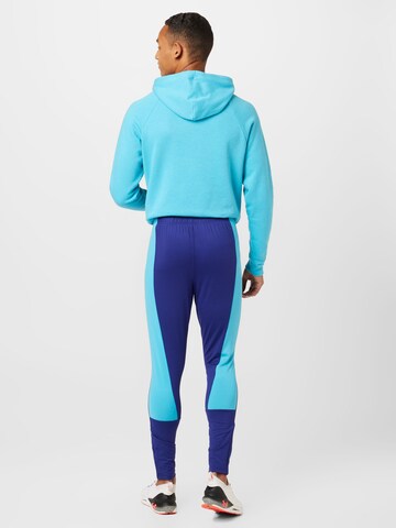 Coupe slim Pantalon de sport UNDER ARMOUR en bleu