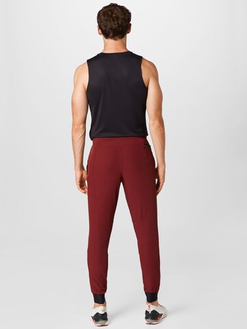 UNDER ARMOUR Regular Sports trousers 'UNSTOPPABLE' in Red