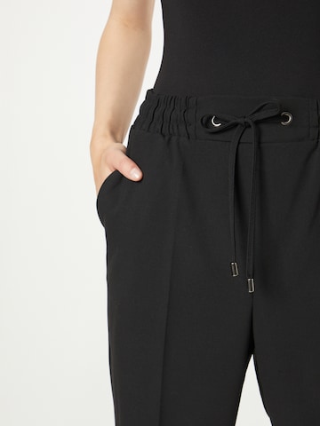 regular Pantaloni con piega frontale di Koton in nero