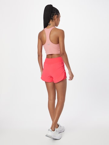 UNDER ARMOUR Loosefit Sportovní kalhoty 'Flex Woven' – pink