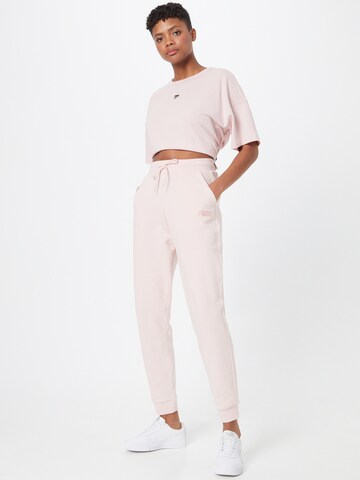 PUMA Tapered Sports trousers 'Her' in Pink