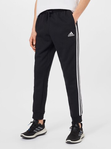 ADIDAS SPORTSWEAR Tapered Sports trousers 'Essentials Fleece Tapered Cuff 3-Stripes' in Black: front