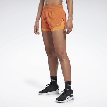 Reebok - Skinny Calças de desporto em laranja: frente