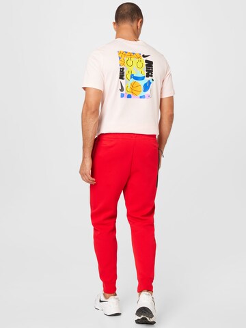 Nike Sportswear Tapered Housut 'Tech Fleece' värissä punainen