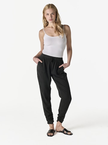 KOROSHI - Tapered Pantalón en negro