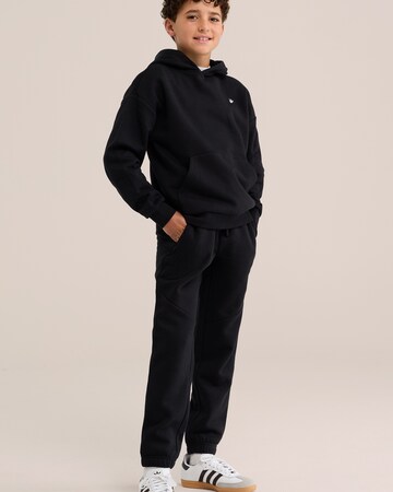 WE Fashion Tapered Housut värissä musta: etupuoli