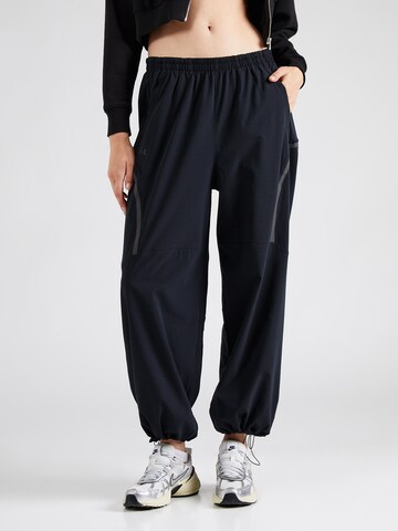 Tapered Pantaloni 'Unstoppable' de la UNDER ARMOUR pe negru: față