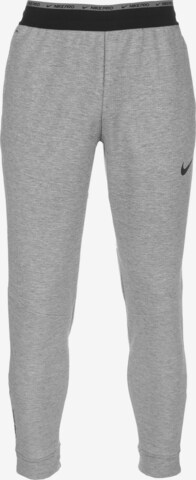 NIKE Tapered Workout Pants in Grey: front