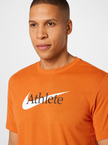 NIKE Regular fit Λειτουργικό μπλουζάκι 'Athlete' σε πορτοκαλί