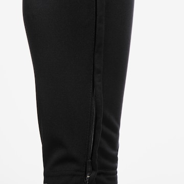 Effilé Pantalon de sport JAKO en noir