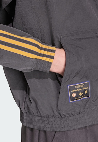 Veste mi-saison 'Manchester United Terrace Icons' ADIDAS ORIGINALS en noir