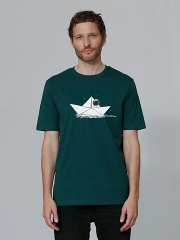 Maglietta ' Astronaut in paper boat ' di Watapparel in verde: frontale