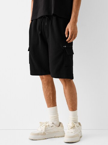 Bershka Loose fit Cargo Pants in Black: front